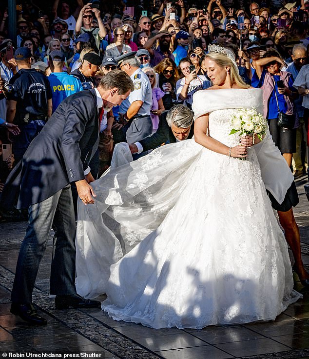 Sporting a traditional white frock, Theodora's strapless dress featured a fold-over neckline, an A-line shaped skirt and a fabric covered in shimmering white beads