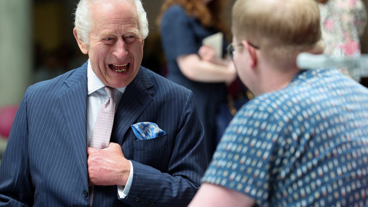 King Charles III meets with patient Jasper Keech during a visit at the University College Hospital Macmillan Cancer Centre on April 30,