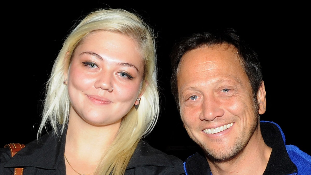 Rob Schneider and daughter Elle King smile.