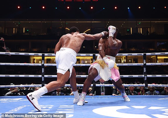 RIYADH, SAUDI ARABIA - MARCH 8: Anthony Joshua knocks down Francis N'Gannou for the 1st time during their Heavyweight Contest at Kingdom Arena on March 8, 2024 in Riyadh, Saudi Arabia. (Photo by Mark Robinson/Matchroom Boxing via Getty Images)