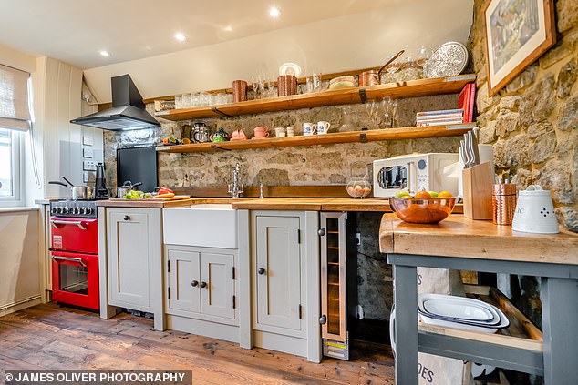 Above is Button Cottage's kitchen, 'where hand-built units have been sympathetically chosen to blend character with modern conveniences'