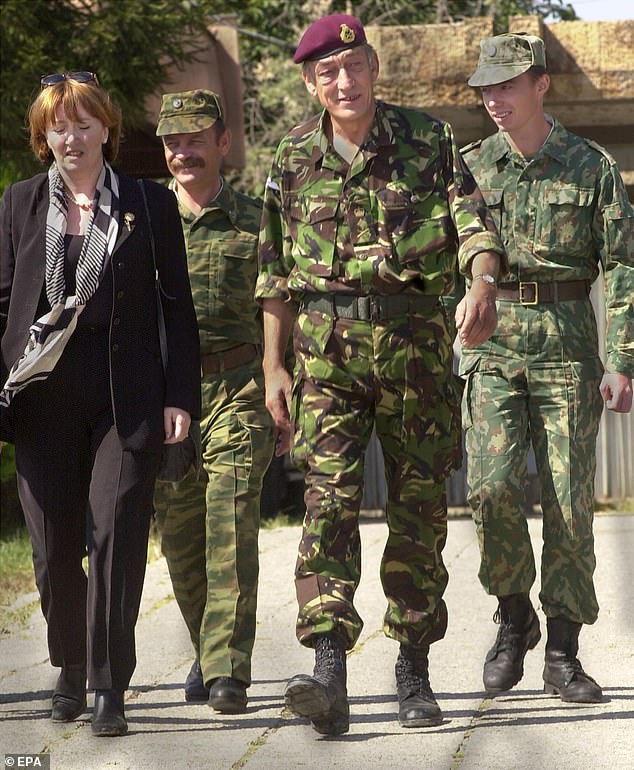 Gen Sir Michael (seen centre) is pictured with nd British defence minister Baroness Symons (left) while walking together with Russian soldiers at Pristina Airport in September 2000