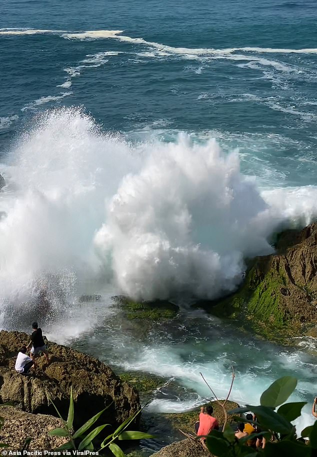 Horror footage captured the moment the tourist was washed away by the huge wave while posing for pictures at the coastal spot