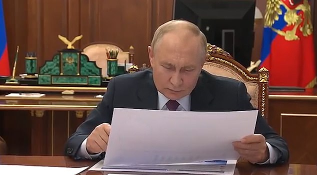 Putin was visibly confused, bowing his head to review the map before realising he'd made a mistake