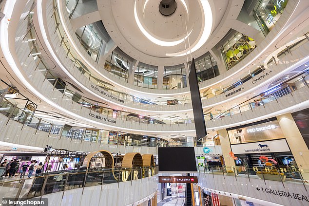 With the addition of hand sanitizers and sprays, indoor spaces have barely been the same since the Covid pandemic. Pictured, a shopping mall in Hong Kong