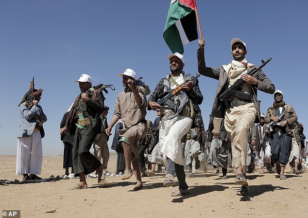 Houthi attacks in the Red Sea have forced major shipping companies to avoid the waterway, impacting international trade. Pictured: Houthi rebel fighters march during a rally of support for the Palestinians in the Gaza Strip and against the US strikes on Yemen outside Sanaa on January 22, 2024