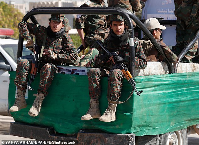 As well as the direct attacks on ships in the Red Sea, the Houthis have fired several missiles and drones at Israel directly. Pictured: Houthi fighters riding a truck patrol during a mass funeral of 29 slain Houthi fighters who were killed in recent fighting against Saudi-backed government forces, in Sana'a, Yemen, January 10, 2022