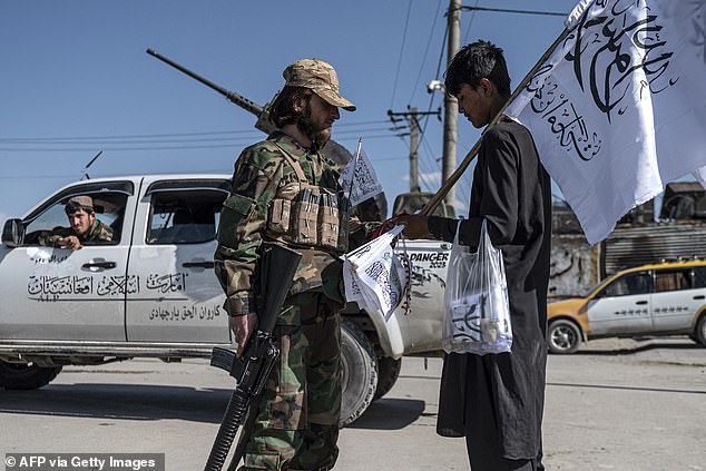 The Islamic Republic has said it hopes to achieve two million deportations by March next year. Pictured: A Taliban security personnel talks with a flag vendor outside the Eid Gah mosque in Kabul on April 20, 2023