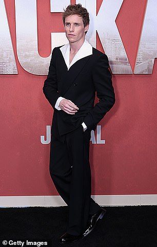 Eddie - who has been labeled as the 'next James Bond' by fans - also walked the red carpet wearing a pair of black trousers as well as a matching blazer and white shirt with dramatic collars underneath