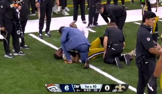 Adebo was left on the floor in pain after attempting to tackle a Broncos running back