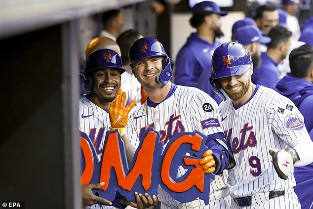 Alonso (center) celebrates his first inning home run with teammates Francisco Lindor (L) and Brandon Nimmo (R) during Game 6 of the NLCS against the Los Angeles Dodgers