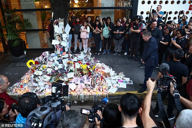 Geoff Payne stands near a makeshift memorial outside the hotel where his son Liam Payne was found dead