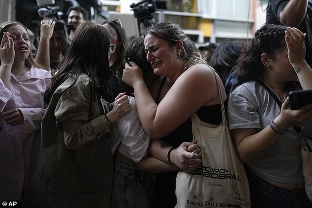 Fans of former One Direction singer Liam Payne grieve outside the Casa Sur Hotel where the British pop singer fell to his death