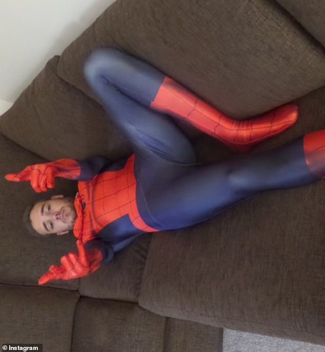 Liam is pictured donning a Spiderman costume as he lies on a sofa and gestures towards the camera. It is one of several unseen pictures of the star shared by his sister Ruth