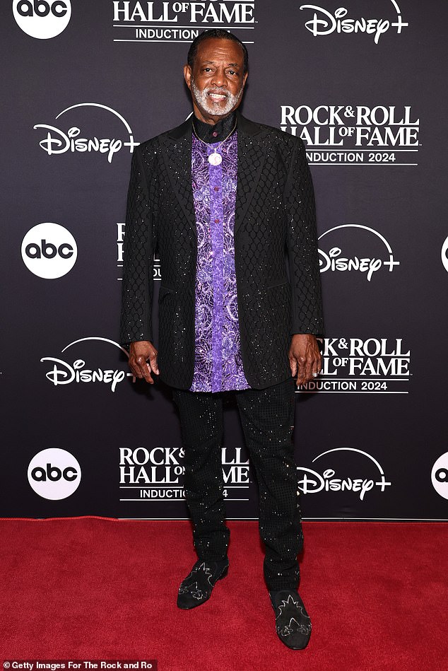 Robert Bell of Kool & the Gang looked was eye-catching in a fun, eccentric outfit at the ceremony. The 74-year-old singer sported a purple patterned top with a black collar, and he layered the button-down with a sequined blazer and rhinestone-covered pants. He also sported dark, suede boots with silver details to complete his look