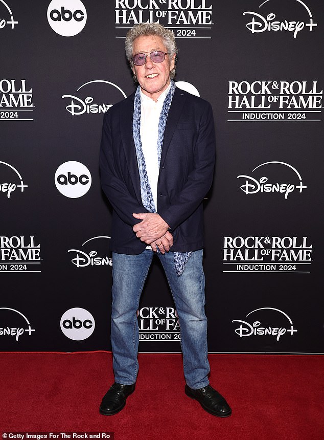 Roger Daltrey, 80, looked dashing in a navy blue blazer paired with a white button-down, a patterned scarf and straight-leg jeans. The founder and lead singer of the Who completed his look with shiny, leather dress shoes