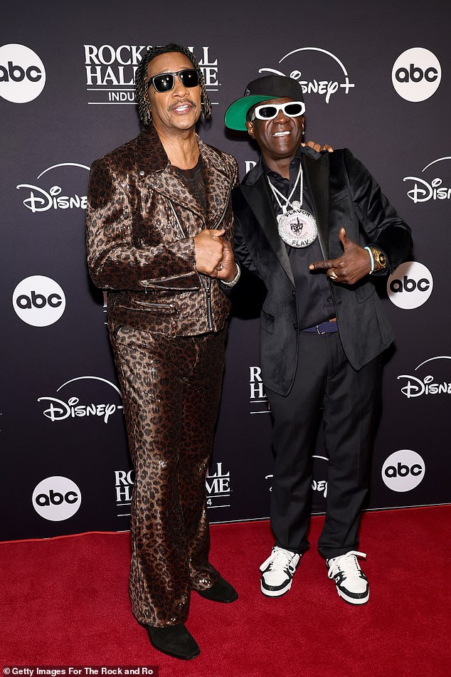 James 'J.T.' Taylor joined Flavor Flav on the red carpet. The 71-year-old singer, who rose to fame as the lead singer of Kool & the Gang between 1979 and 1988, looked dapper in an animal-print, sequined motorcycle jacket paired with matching trousers and black, suede boots