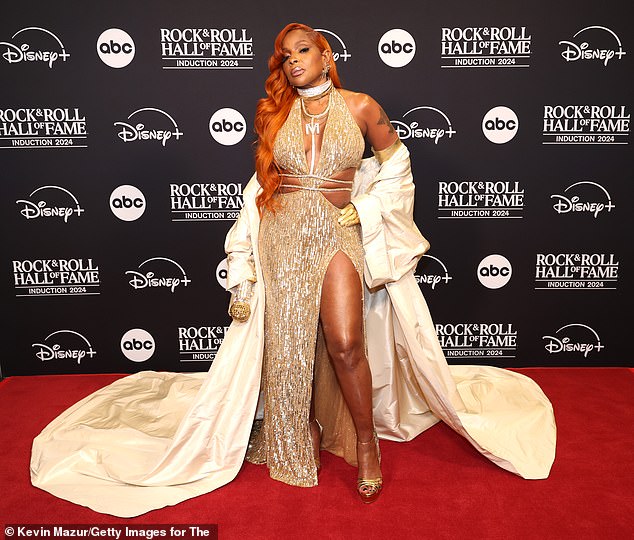 Mary J. Blige looked ethereal as she arrived, gilded in gold for her red carpet walk. The Family Affair hitmaker, 53, showcased her hourglass figure in a plunging, sequin-covered gown with thin straps and a sexy, thigh-high slit