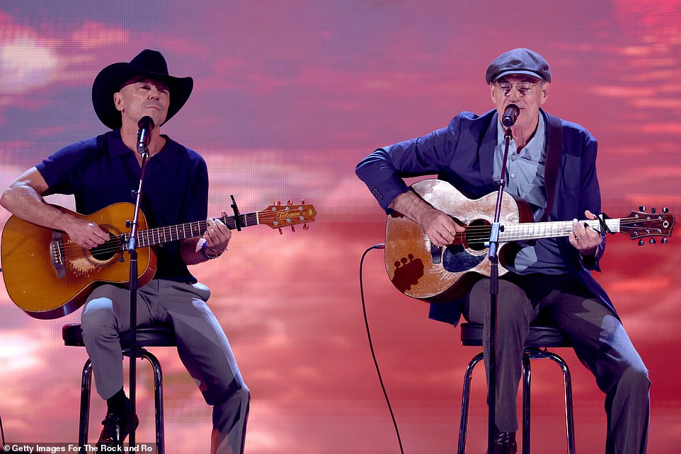 The trio were seen playing guitars as they sat on top of stools in front of microphones on the stage