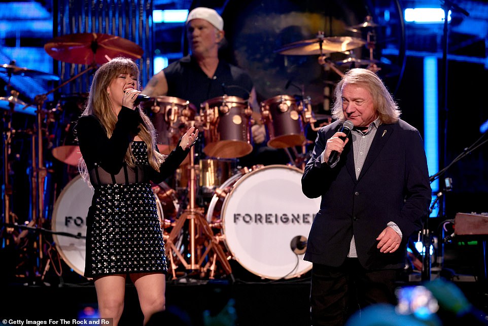 The pair stood near a drum set as they belted out lyrics in front of the guests inside the venue