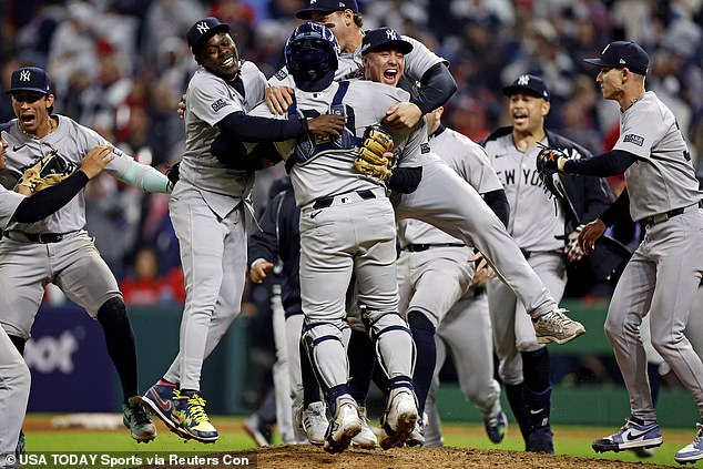 The New York Yankees mob the mound as they advance to their first Fall Classic since 2009