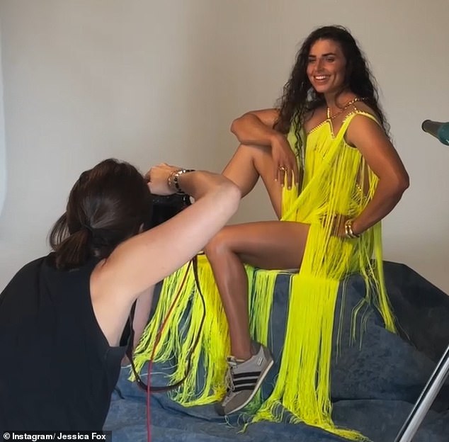 Fox poses for a magazine cover shoot, later revealing tape was required to hold the dress together because her broad shoulders wouldn't comfortably fit into the outfit