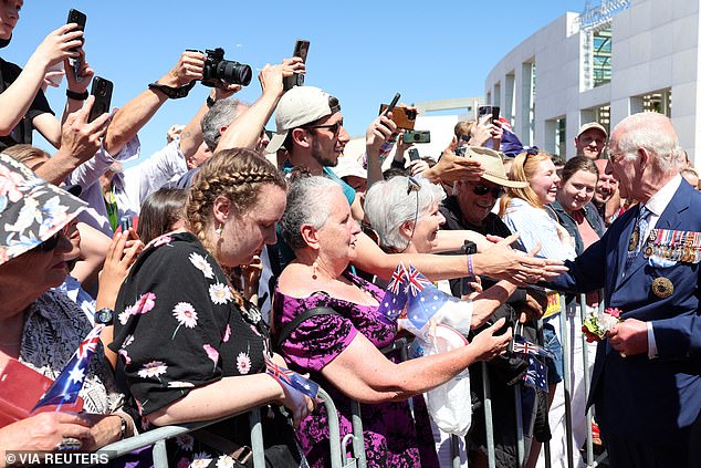 King Charles III meets members of the public during a walkabout outside Parliament House