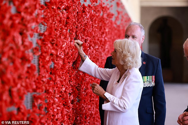 Queen Camilla also inspected the war memorial beside her husband the King