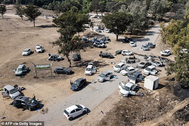 This aerial picture shows abandoned and torched vehicles at the site of the October 7 attack on the Supernova desert music Festival by Palestinian militants near Kibbutz Reim in the Negev desert in southern Israel on October 13, 2023