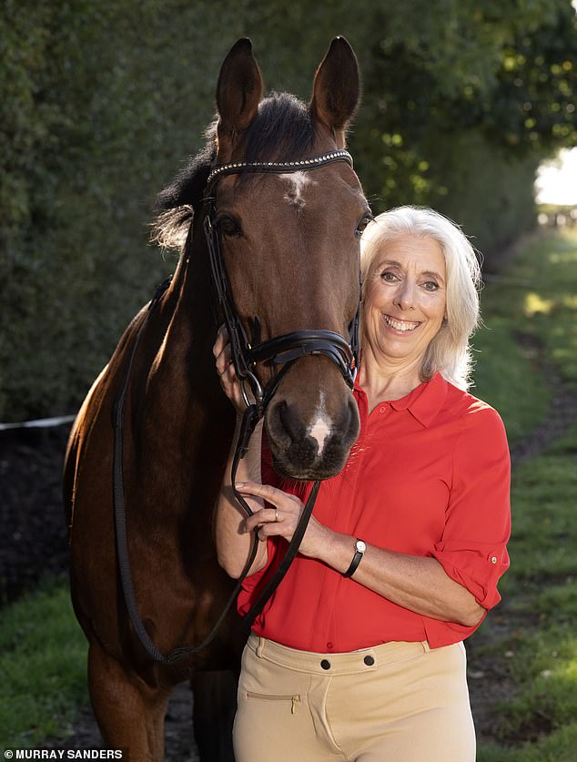 Claire Howard, 61, with her horse Fin, an Irish draught cross thoroughbred who she bought for £3,000 in November 2009