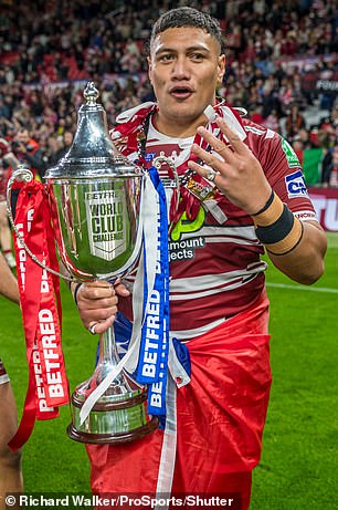 Grasping the World Club Challenge cup, Patrick Mago was keen to show the cameras just how many trophies Wigan had won this season