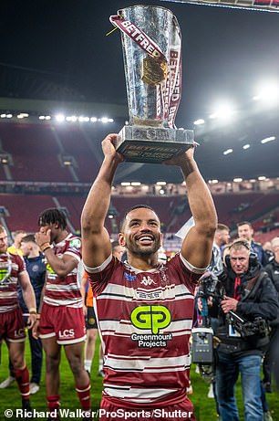 Kruise Leeming celebrates with the trophy after Wigan's Grand Slam triumph