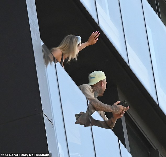 Jamie, with her blonde locks swept under a chic headband, was beaming as she pointed in the Queen's direction, while Dave, wearing a backwards cap and showing off his inked arms, filmed the moment on his phone