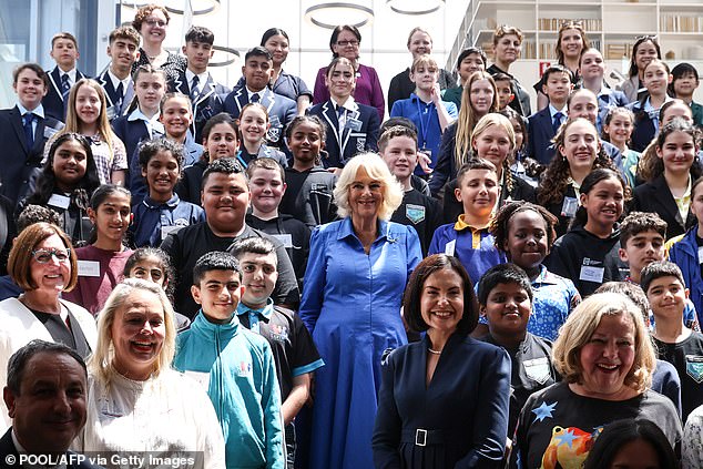 The Queen posed with students, authors and book club members after presenting certificates to past participants of the Queen's Commonwealth Essay Competition, an annual competition run by the Royal Commonwealth Society.