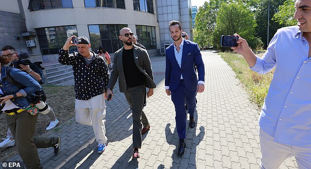 Former professional kickboxer and social media influencer Andrew Tate (C-L) and his brother Tristan (C-R), assisted by their bodyguards and surrounded by journalists, leave the building after a pre-trial hearing for lifting the seizure of assets held at the Bucharest Court, in Bucharest, Romania, 23 September 2024