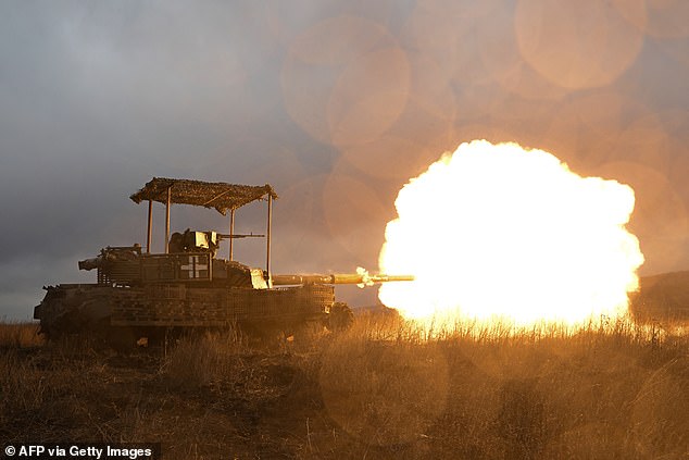 Ukrainian servicemen fire with a tank as they check it after a maintenance not far from Bakhmut in the Donetsk region on February 5, 2024