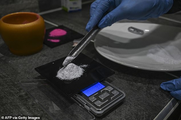 Instead analysis suggests it is most often a mix of the tranquilizer and hallucinogen ketamine, the stimulant and psychedelic MDMA, amphetamines like meth. Pictured a man weighing out ketamine to form pink cocaine