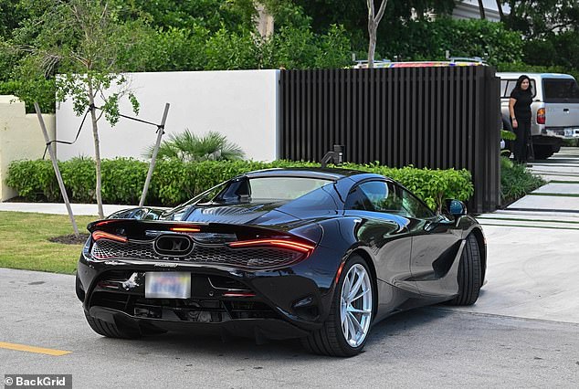 Beckham arrives at the home in his McLaren 750S which sells new for upwards of £240,000