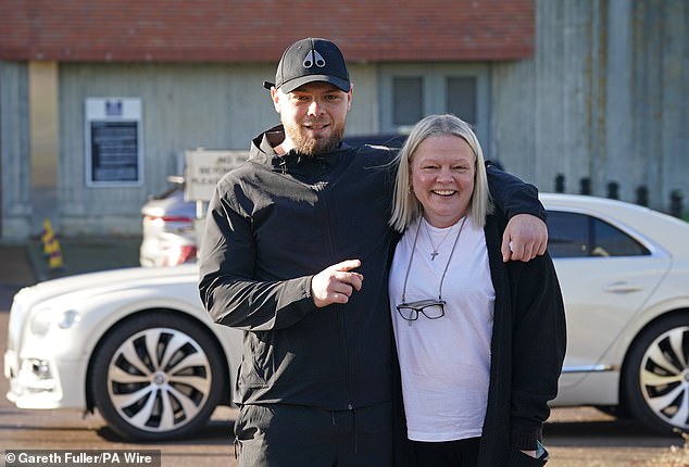 He posed on Tuesday morning alongside his mother Sarah outside HMP Swaleside in Kent