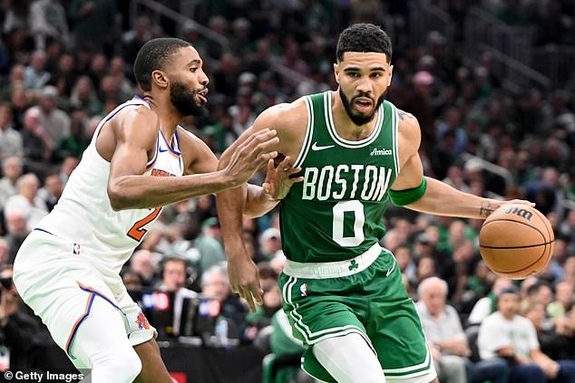 Jayson Tatum of the Boston Celtics drives on Knicks forward Mikal Bridges on Tuesday