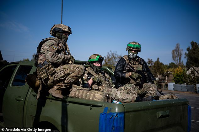 Ukrainian soldiers from the Liut Brigade sit in a pickup truck on their way back to the frontline town near Chasiv Yar in Donetsk Region, Ukraine on October 7, 2024