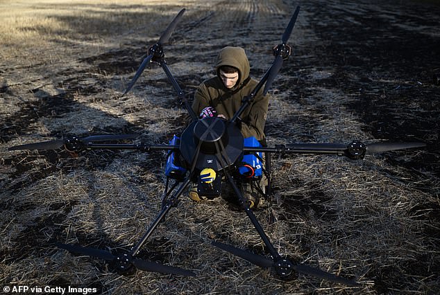 A Ukrainian serviceman of the 30th separate mechanized brigade prepares to run tests flights of a hexacopter drone ahead of battle mission in the eastern Donetsk region on October 22, 2024