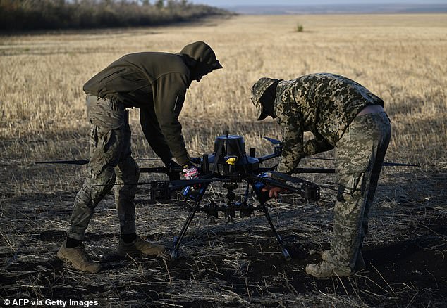 Ukrainian servicemen of the 30th separate mechanized brigade prepare to run tests flights of a hexacopter drone ahead of battle mission in the eastern Donetsk region on October 22, 2024