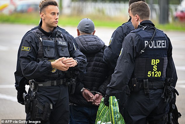 Officers detain a man on the German/French border in Kehl, western Germany