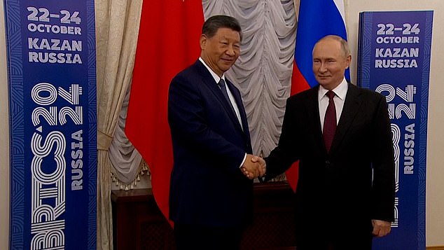 Upon seeing his Chinese counterpart, Putin's face broke out into a smile, and the pair cordially shake hands and pose for the photo-op