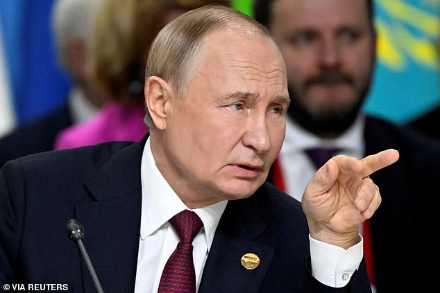 Russia's President Vladimir Putin points during the extended format meeting of the BRICS summit in Kazan, Russia on October 23