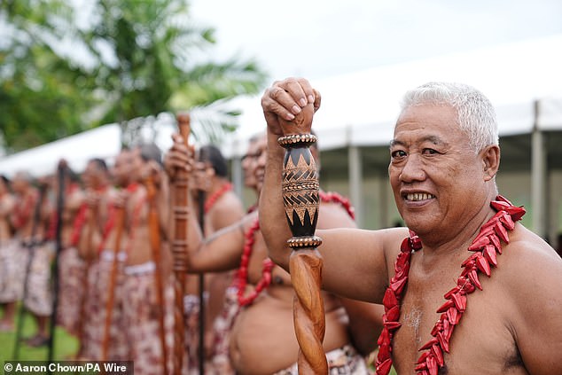 Village community members wait for the arrival of Charles and Camilla ahead of the official royal 'ava ceremonial' welcome