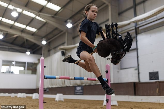 PETA wants organisers to ditch bucking broncos and switch to getting jackaroos and jillaroos to ride hobby horses instead, like this competitor at the UK Hobby Horse Championship