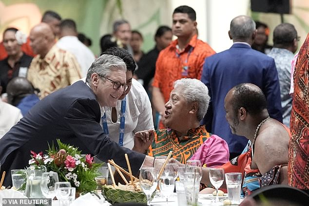 Sir Keir glad-handing at a banquet with other Commonwealth representatives today