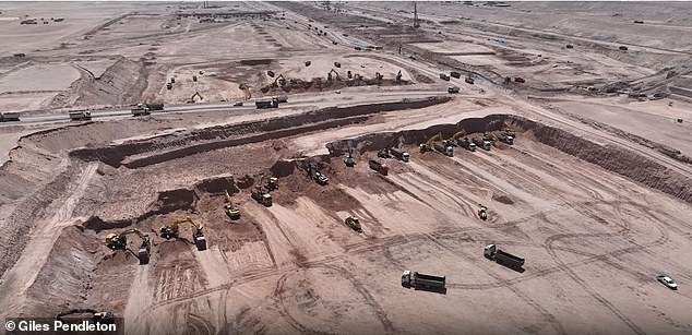 Diggers and trucks work at the foundations of The Line